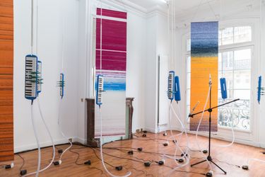 Tromarama, Beta (2019). Melodica, c-clamp, rope, soprano recorder, mic stand, DC fan, hose, hose clamp, chains, digital print on fabric, software, #nationality. Variable dimension. Exhibition view: Paris Internationale (2019). Courtesy the artists and ROH.Image from:Tromarama: Rethinking the Locales of the Global SystemRead ConversationFollow ArtistEnquire