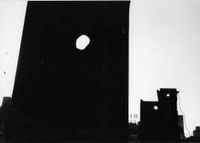 Untitled (Dark silhouettes of buildings with three round holes, sign with “RI”) by Louis Draper contemporary artwork sculpture, photography