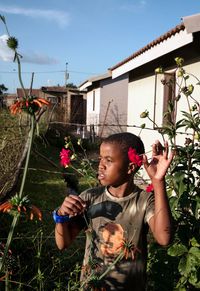 Yonelisa Samela in his grandmother's garden during South Africa's first lockdown by Lindokuhle Sobekwa contemporary artwork print