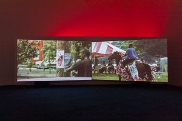 Mohamed Bourouissa, Horse Day (2014–2015). Video diptych (colour, sound). 13 min, 32 sec. Exhibition view: HARa!!!!!!hAaaRAAAAA!!!!!hHAaA!!!, Goldsmiths CCA, London (21 May–1 August 2021). © Mohamed Bourouissa, Adagp, Paris, 2023. Courtesy the artist and Mennour, Paris. Photo: Mark Blower.Image from:Mohamed Bourouissa Won't Take a Single PositionRead ConversationFollow ArtistEnquire