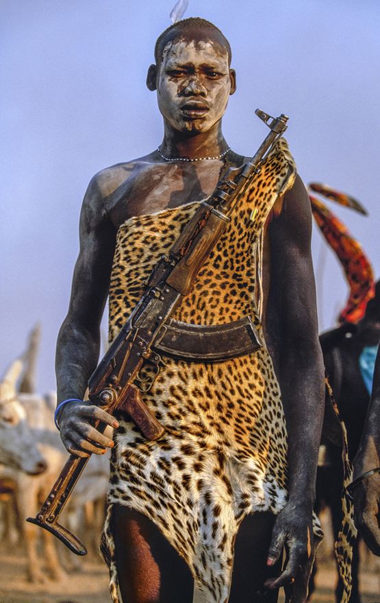 Dinka Warrior with Leopard Skin and Kalashnikov Rifle South Sudan by Carol Beckwith  Angela Fisher contemporary artwork Print