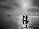 At daybreak Waura Indians travel by canoe to collect the waiting net Xingu Indigenous Territory state of Mato Grosso Brazil by Sebastiao Salgado contemporary artwork Photography