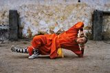 Young monk practicing Shaolin one of the oldest styles of Kung Fu Shaolin Monastery Henan Province China by Steve Mccurry contemporary artwork photography