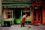 A man sweeps outside a bakery New York NY USA by Steve Mccurry contemporary artwork Photography