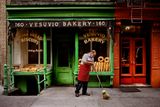 A man sweeps outside a bakery New York NY USA by Steve Mccurry contemporary artwork photography