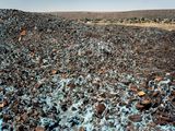 Highly carcinogenic blue asbestos waste on the Owendale Asbestos Mine tailings dump near Postmasburg Northern Cape. The prevailing wind was in the direction of the mine officals houses at right. 21 December 2002 by David Goldblatt contemporary artwork print