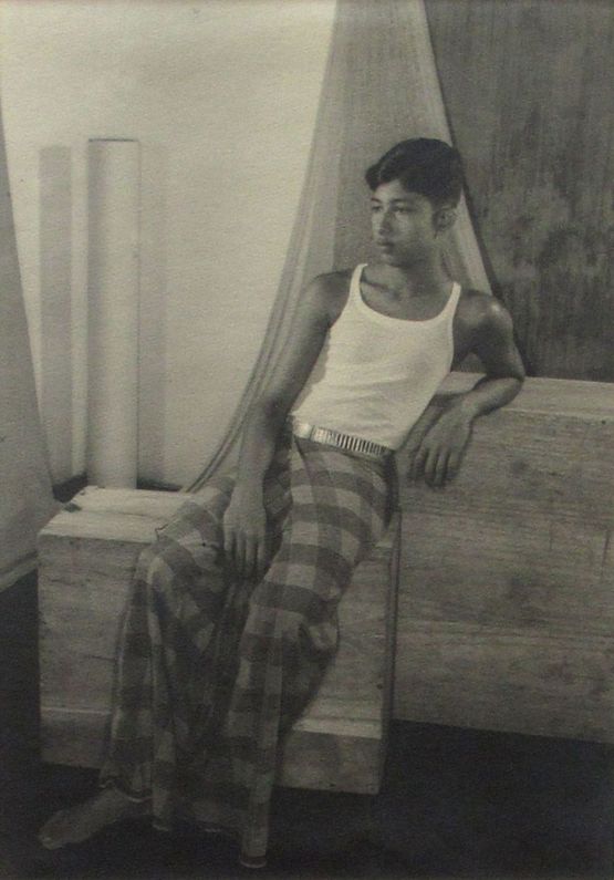 Male seated on the wooden block by Lionel Wendt contemporary artwork Photography